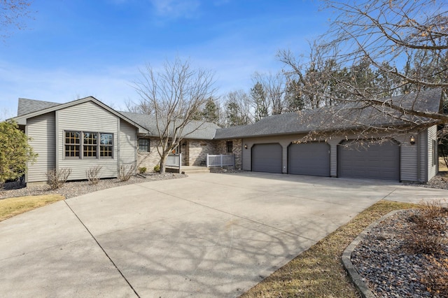 view of front of home with a garage, central air condition unit, concrete driveway, and a shingled roof