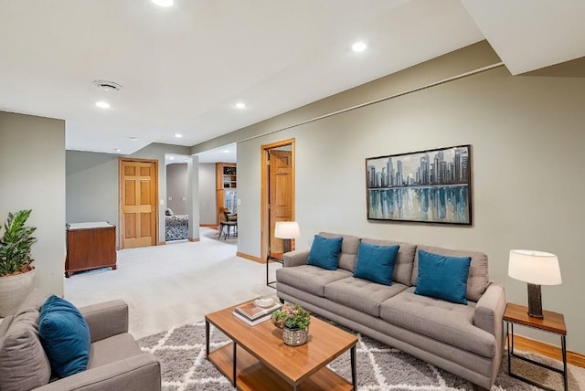 living area with recessed lighting, light colored carpet, and baseboards