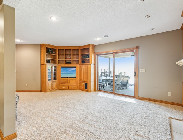 unfurnished living room featuring recessed lighting, light colored carpet, baseboards, and a textured ceiling