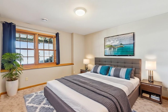 carpeted bedroom featuring baseboards