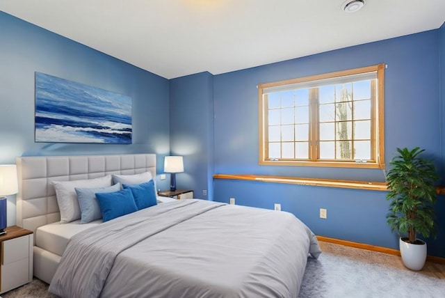 carpeted bedroom featuring baseboards