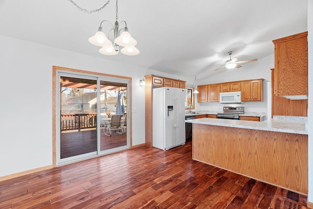 kitchen featuring a sink, stainless steel appliances, dark wood finished floors, and light countertops