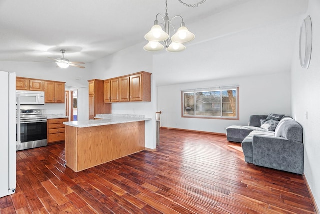 kitchen with dark wood-type flooring, open floor plan, light countertops, a peninsula, and white appliances