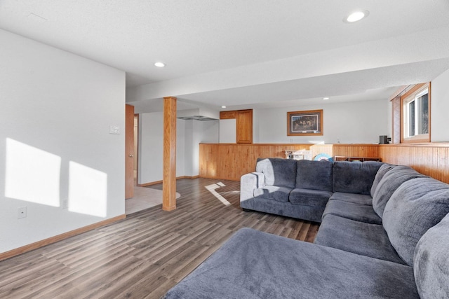 living room featuring recessed lighting, baseboards, and wood finished floors