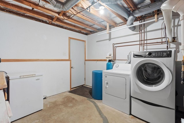 clothes washing area with laundry area and washer and clothes dryer