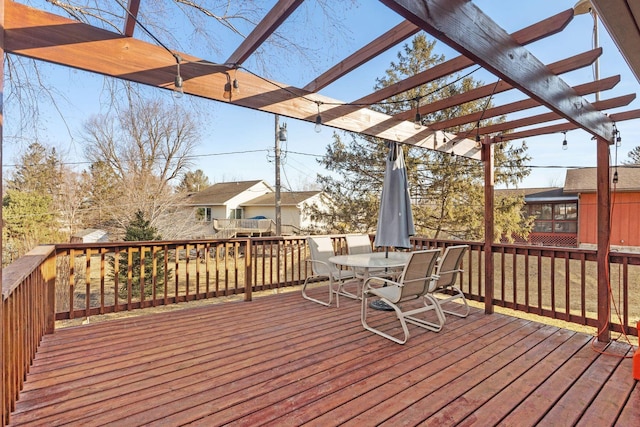 deck featuring outdoor dining space and a pergola