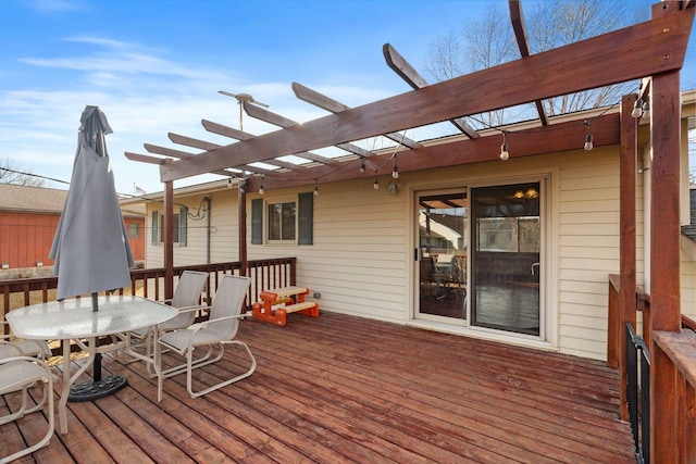 wooden terrace with outdoor dining space and a pergola