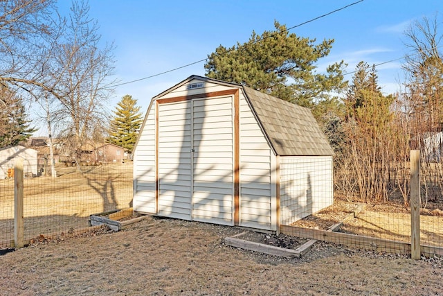 view of shed featuring fence