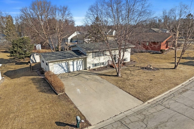 view of front of home with driveway and a garage