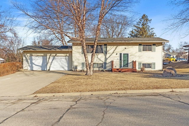 bi-level home featuring a garage and driveway