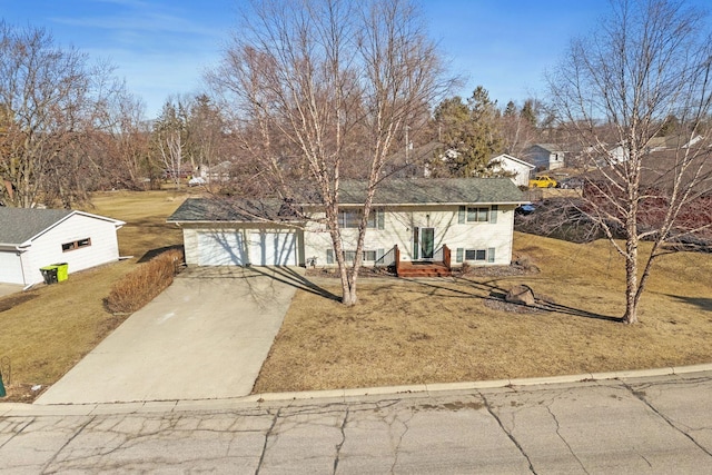 view of front of house with driveway, a front yard, and a garage