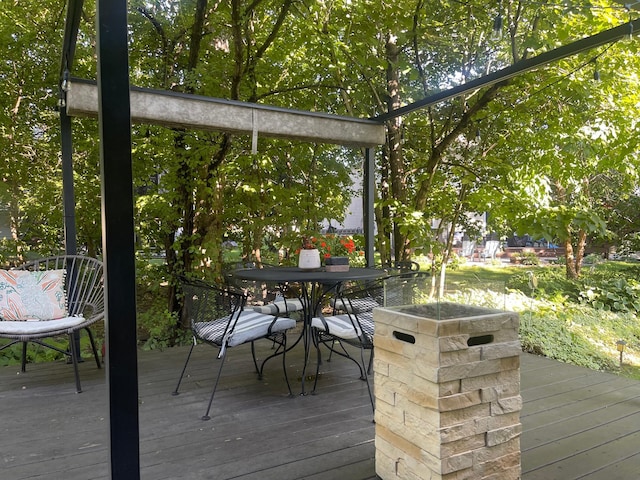 wooden terrace with outdoor dining area