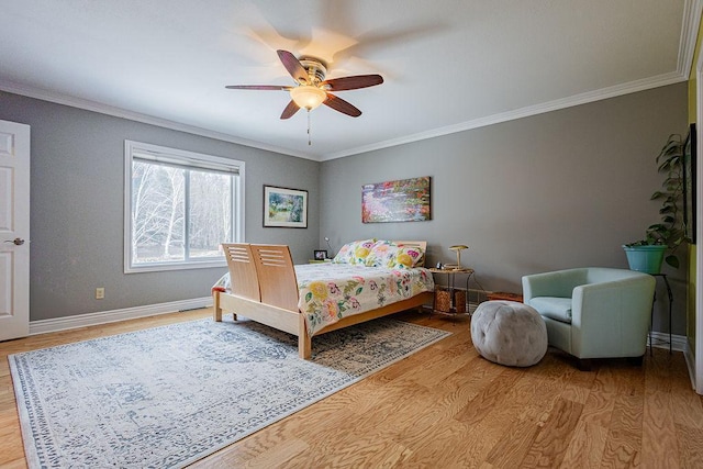 bedroom with ornamental molding and wood finished floors