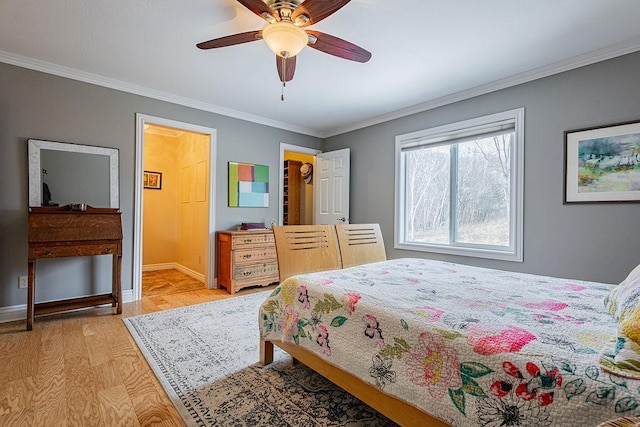 bedroom featuring light wood-type flooring, baseboards, ceiling fan, and crown molding