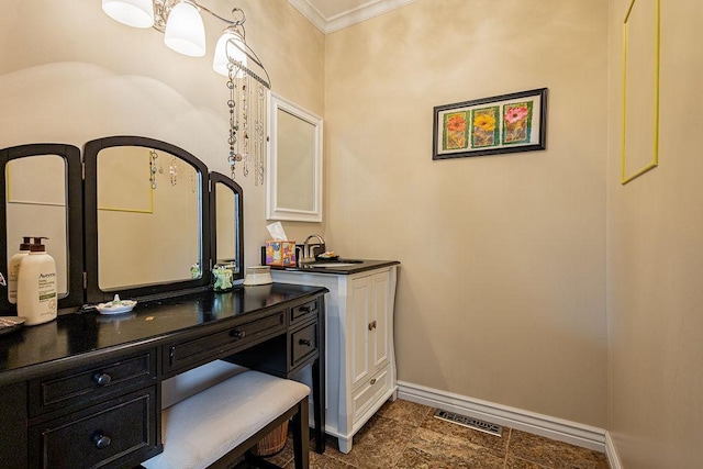 bathroom featuring visible vents, vanity, crown molding, and baseboards