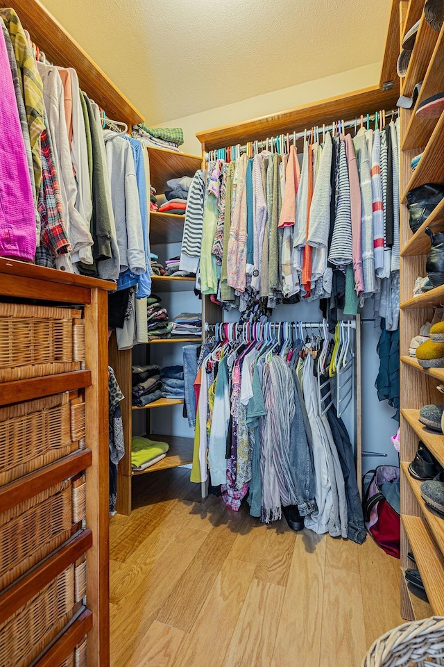 walk in closet featuring wood finished floors