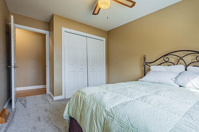 bedroom with a closet, baseboards, carpet, and ceiling fan