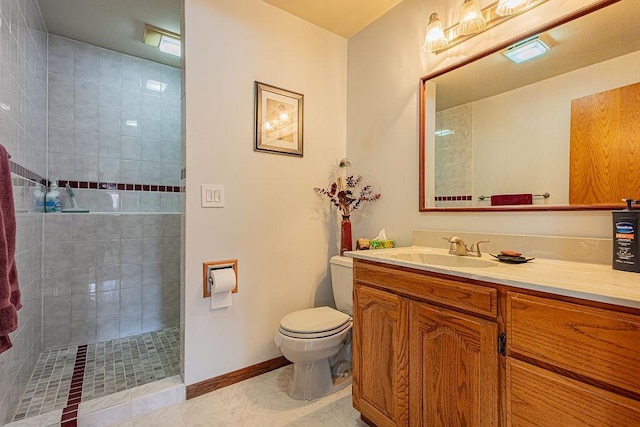 full bathroom with baseboards, toilet, tiled shower, tile patterned floors, and vanity