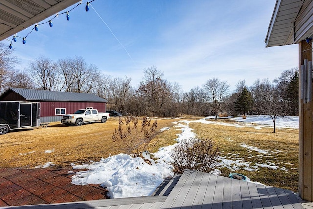 snowy yard featuring an outdoor structure