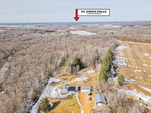 birds eye view of property with a forest view