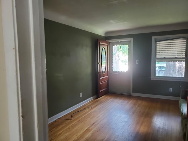 entrance foyer featuring wood finished floors and baseboards