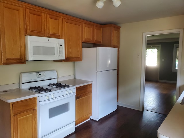 kitchen featuring white appliances, brown cabinetry, baseboards, dark wood-style flooring, and light countertops