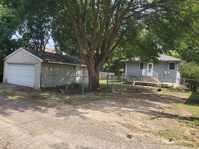 exterior space with a garage, an outdoor structure, and fence