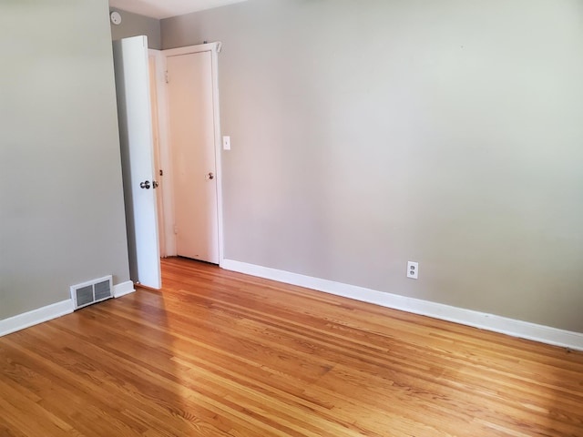 unfurnished room with baseboards, visible vents, and light wood-type flooring