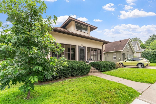 view of front facade featuring stucco siding and a front lawn