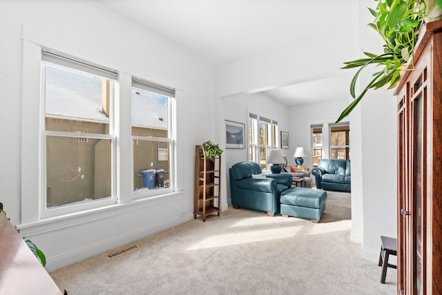 interior space featuring carpet flooring, baseboards, and visible vents