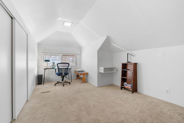 carpeted office space with visible vents and lofted ceiling