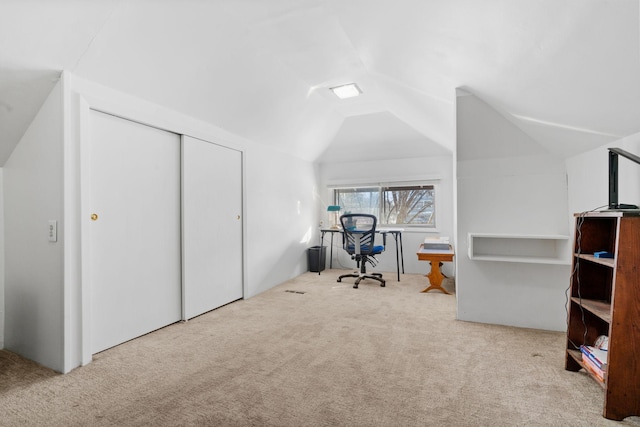 unfurnished office with carpet flooring and vaulted ceiling