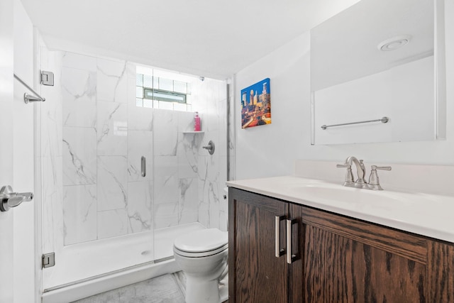 full bathroom with a marble finish shower, toilet, and vanity