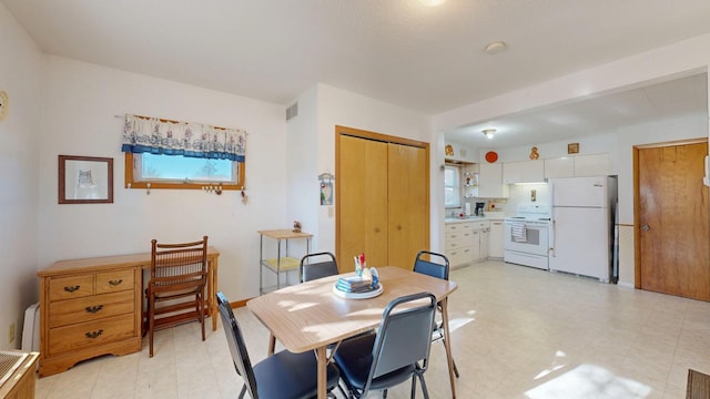 dining area featuring light floors, visible vents, and a wealth of natural light