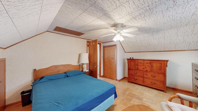 bedroom featuring baseboards, lofted ceiling, ornamental molding, ceiling fan, and light colored carpet