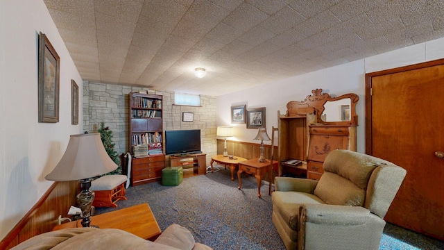 living room featuring a wainscoted wall, wooden walls, and carpet floors