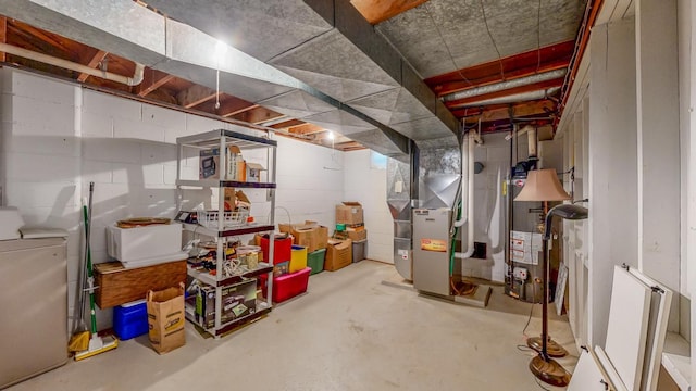 unfinished below grade area featuring washer / dryer, concrete block wall, heating unit, and water heater