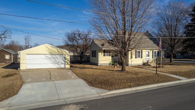 view of front facade featuring an outdoor structure, fence, and a garage