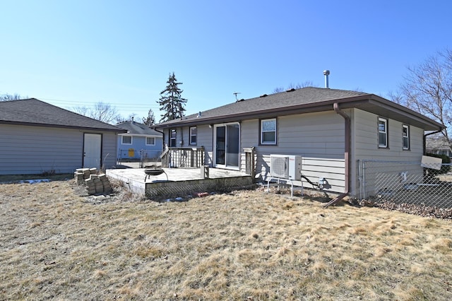 back of property with a deck and fence