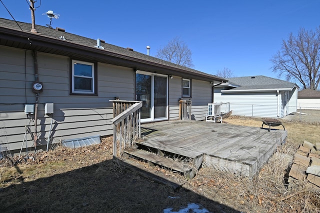 back of property with central AC and a wooden deck