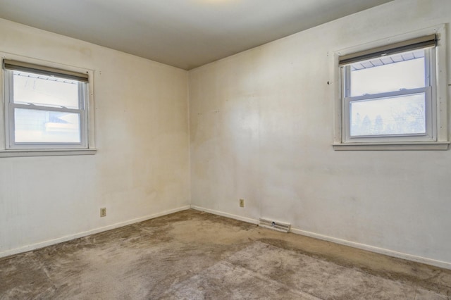 spare room with visible vents, baseboards, and carpet