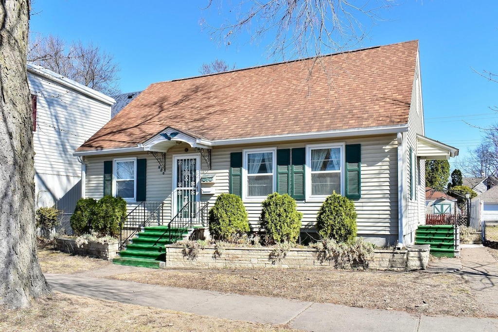 view of front of home featuring roof with shingles