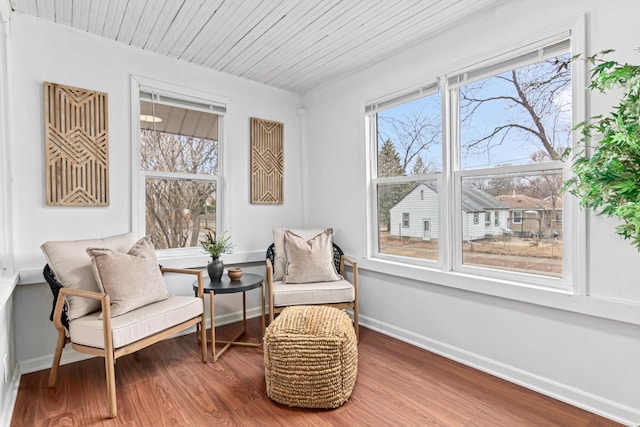 living area featuring wood ceiling, wood finished floors, and baseboards