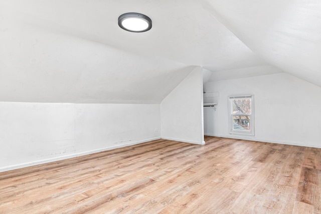 bonus room featuring lofted ceiling and wood finished floors