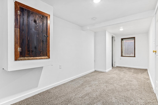 unfurnished room with baseboards and carpet flooring