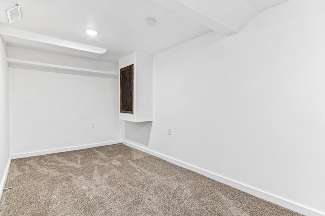 carpeted spare room featuring visible vents and baseboards