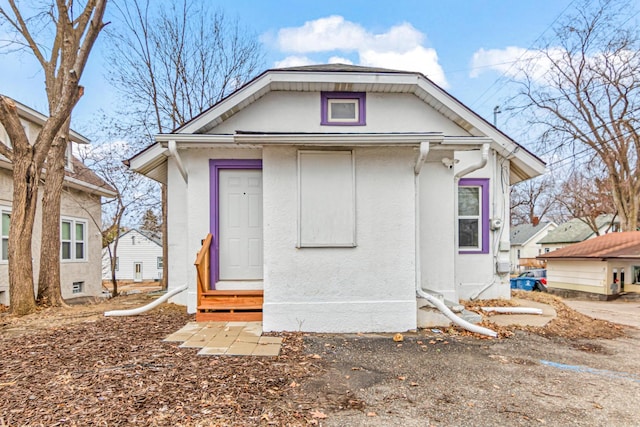 view of front of home with entry steps and stucco siding