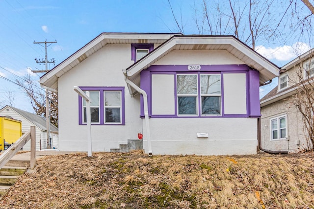 view of side of property featuring crawl space and stucco siding