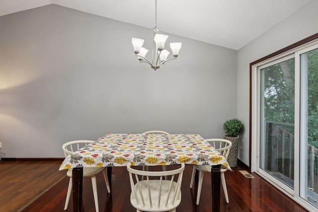 dining space with baseboards, lofted ceiling, an inviting chandelier, and dark wood-style floors