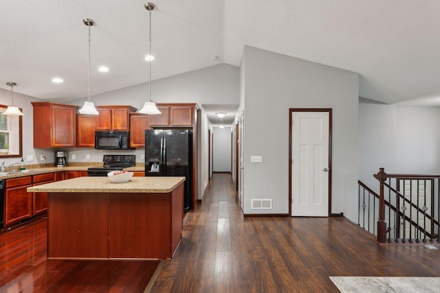 kitchen featuring visible vents, a center island, decorative light fixtures, dark wood-style floors, and black appliances